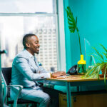 corporate-african-man-using-a-computer-at-his-desk