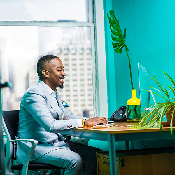 corporate-african-man-using-a-computer-at-his-desk