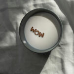 wow spelled out in a cup of milk